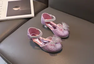 Detail of pink glitter princess shoe with rhinestone bow and mary jane strap