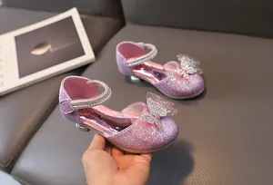 Detail of pink sequined girls princess shoes with rhinestone bow and glitter finish