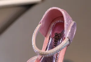 Close-up of pink glitter girls princess shoes with rhinestone strap and fashion logo