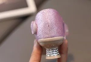 Close-up of pink glitter girls' princess shoes featuring rhinestone-encrusted low heels
