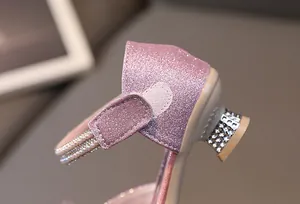 Detail of pink glitter princess shoes with rhinestone heels and pearl straps