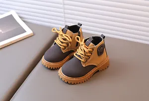 Detail of kids yellow and grey boots featuring side zipper and non-slip rubber soles