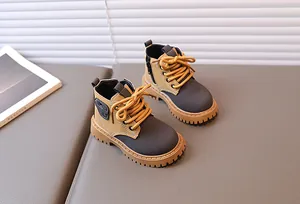 Detail of yellow toddler boots with side zipper and rugged non-slip rubber sole