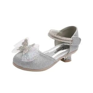 Close-up of girls' silver glitter princess sandals with rhinestones and pearl strap