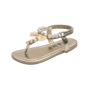 Sandali bambina color oro champagne con perle, fiocco e cinturino elastico