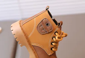 Detail of kids' tan work boots showing stitched side pocket and anti-slip rubber sole
