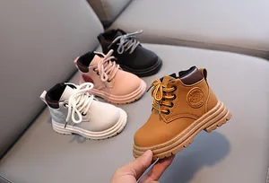 Close-up of durable rubber sole and side embossed logo on premium kids ankle boots