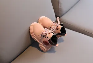 Detail of pink children boots with slip-resistant rubber soles and fashion logo