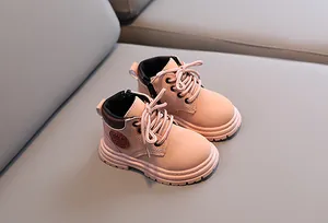 Detail view of pink leather kids' boot showing the side metal zipper and logo embossing