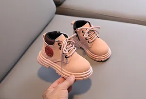 Close-up of pink toddler martin boots with soft rubber sole and side fashion label