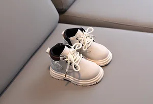 Detail of kids' cream boots featuring side zipper, lace-up front, and non-slip thick sole