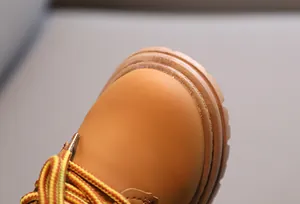 Detail view of durable wheat yellow toddler boots featuring rubber anti-slip thick soles
