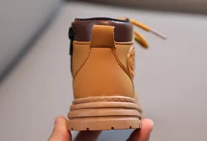 Detailed back view of children's yellow boots showing smooth zipper and durable rubber sole