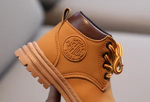 Detail of children Martin boot featuring a classic round embossed sports fashion side logo