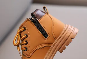 Detail shot of the side zipper and precision stitching on children's leather boots