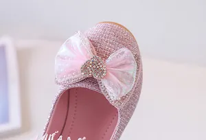 Detailed view of pink glitter girl's princess shoe with mesh bow and heart rhinestone