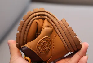 Macro shot of a brown children's boot showing flexible non-slip rubber sole for comfort