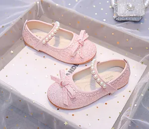 Pink sequin girls Mary Jane shoes featuring a pearl strap and a delicate bow detail