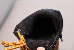 Detail view of the breathable mesh lining and side zipper on children's boots