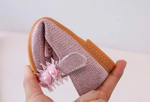 Detail showing the flexible soft sole of pink sequin girls princess shoes with pearl flower