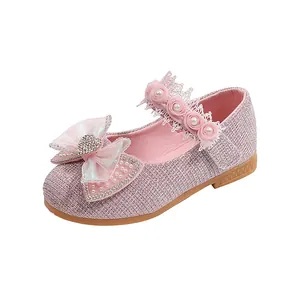 Detail of pink sequin girl shoes with lace flower strap and sparkling heart bow