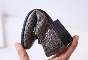 Detail showing the ultra-flexible rubber sole and soft embossed leather for boys' shoes