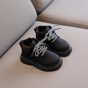 Black kids' Martin boots with brown collar details and thick non-slip rubber soles