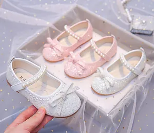 Detailed macro view showing sequins and pearl strap of girls princess Mary Jane shoes