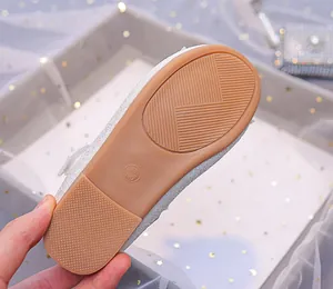 Detailed macro view of the non-slip rubber sole and size marking 28 for girls shoes