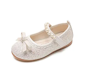 Detail of girls ivory sparkle Mary Jane shoes with sequins and pearl strap bow