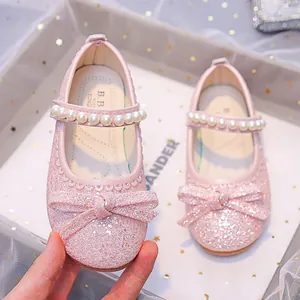 Pink glitter girls princess shoes with large bow and pearl ankle strap for toddlers