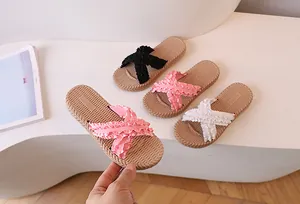 Detail of woven texture sole and ruffled strap on women's stylish flat slide sandals