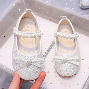 Silver sparkly Mary Jane shoes for girls with large bow and pearl ankle strap detail
