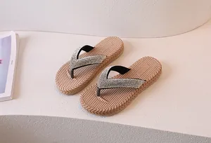 Detail view of sparkly silver rhinestone straps and non-slip woven texture flip flops