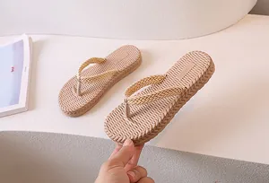 Detailed view of women's flip-flops showing woven texture and non-slip sawtooth sole