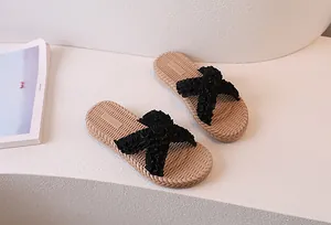 Detail of elegant black pleated chiffon straps and woven texture non-slip sole slippers