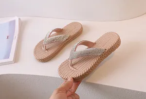 Detail of sparkling rhinestone straps and woven texture sole on women flip flops