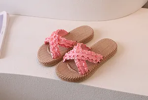 Detailed view of pink ruffled cross-strap sandals with natural woven texture footbed
