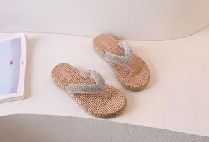 Macro detail of beige flip flops with sparkling rhinestone straps and textured footbed