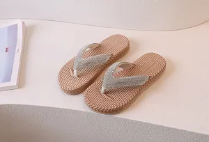 Close-up of sparkling rhinestone straps and non-slip woven texture sole on beach flip flops
