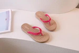 Detail of rose red woven straps and anti-slip textured beige sole for beach flip flops