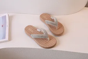 Macro detail of flip flops featuring sparkling rhinestone straps and woven texture soles