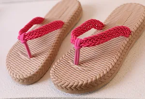 Close-up of beach flip flops with woven rope straps and textured non-slip footbed