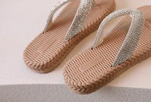 Detail of rhinestone flip flops featuring textured footbed and size 27-28 engraving