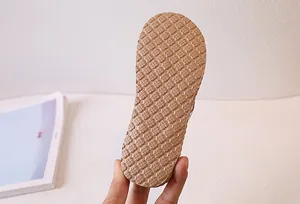 Detailed view of the anti-slip hexagonal honeycomb texture on the khaki sandal sole