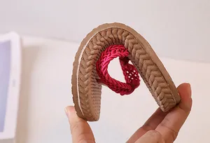 Detail showing the flexible soft sole of flip-flops being bent to demonstrate comfort