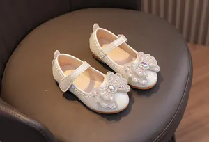 Detailed view of girls pearl bow princess shoes with textured leather and non-slip sole