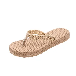Detailed close-up of women's flip-flops featuring elegant braided straps and textured soles