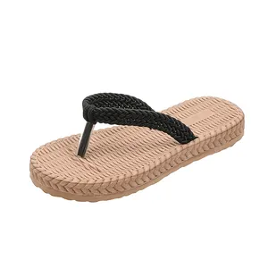 Close-up of woven straps and textured anti-slip sole on casual women's flip flops