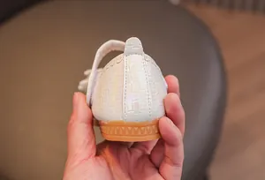 Detail of girls' pearlescent princess shoes with anti-slip rubber sole and velcro strap